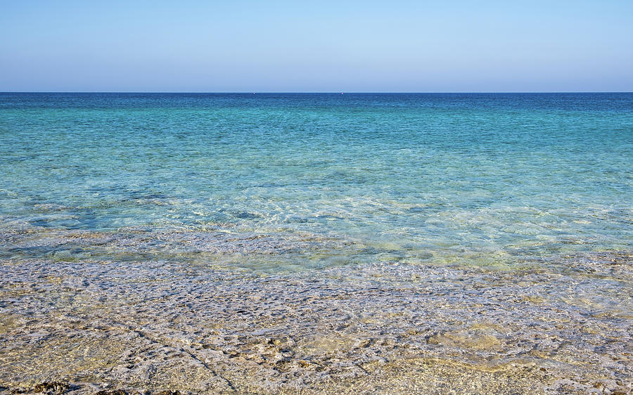 Seascape with turquoise clear blue water and blue sky with copy space. Photograph by Michalakis Ppalis
