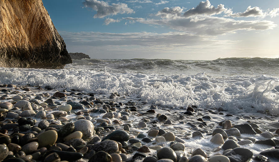 Seascape with windy waves splashing on the pebble beach Photograph by Michalakis Ppalis