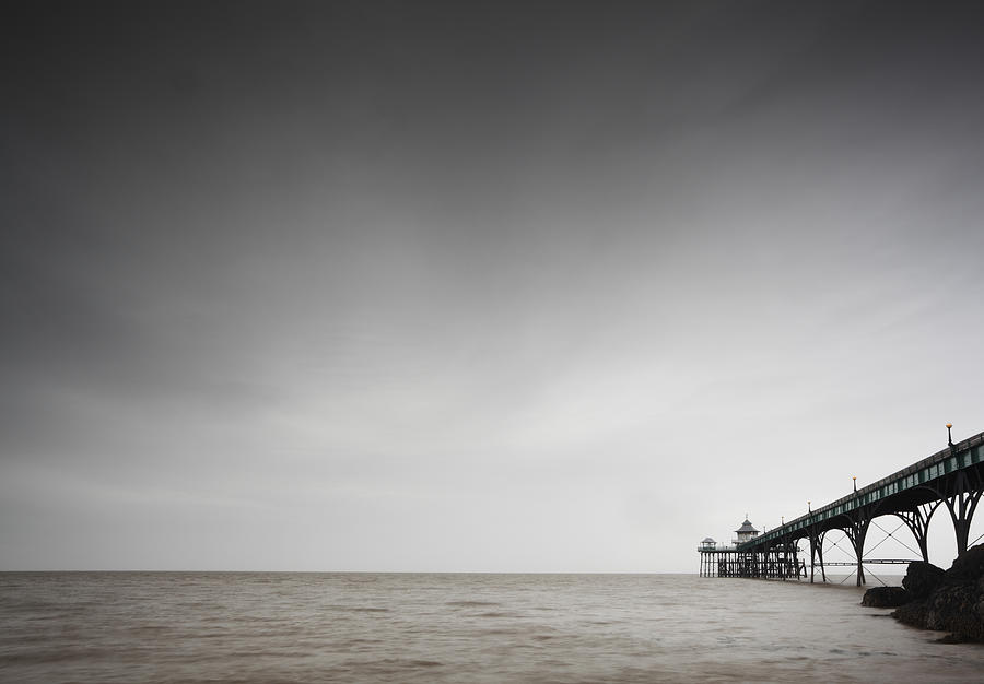 Seaside pier on a gloomy day Photograph by James Osmond