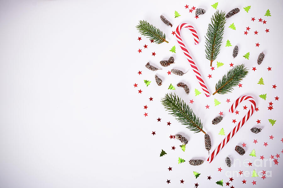 Seasonal composition with fir branches, candy cane and confetti Photograph by Mendelex Photography