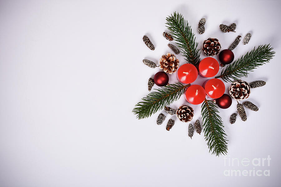 Seasonal greeting card concept with candles and pinecones Photograph by Mendelex Photography