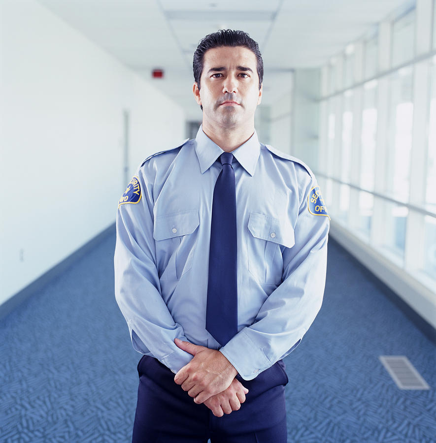 Security guard at airport, portrait Photograph by Ryan McVay