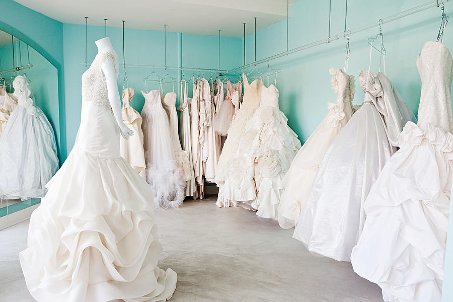 Selection of wedding dresses in boutique Photograph by Image Source