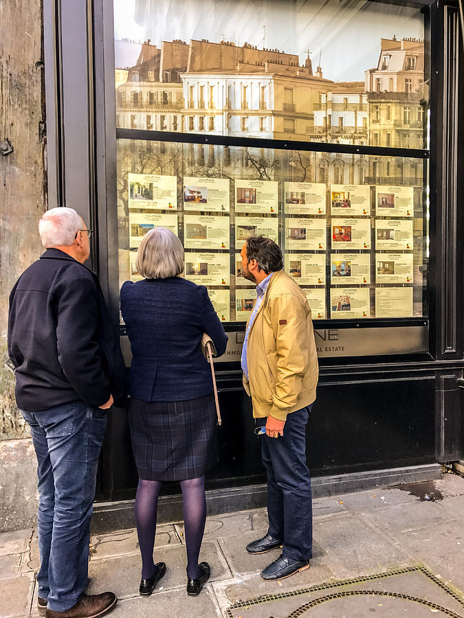 Senior adults looking at Real Estate for rent and sale in Paris, France Photograph by Anouchka