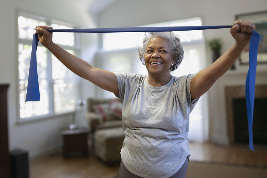 Senior african-american woman exercising inside the house Photograph by SelectStock