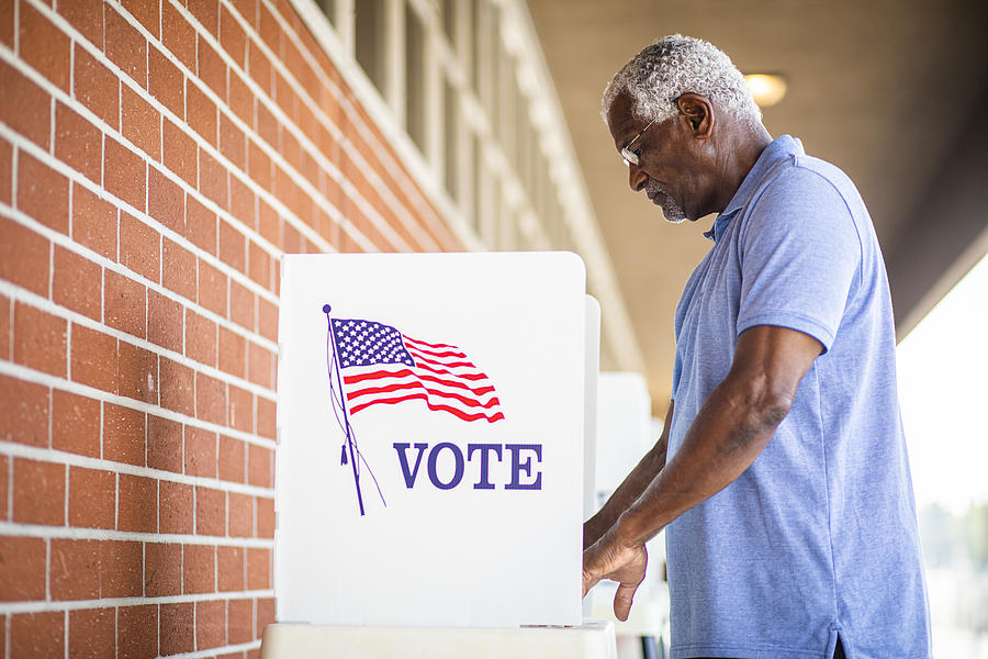 Senior Black Man Voting at Booth Photograph by Adamkaz