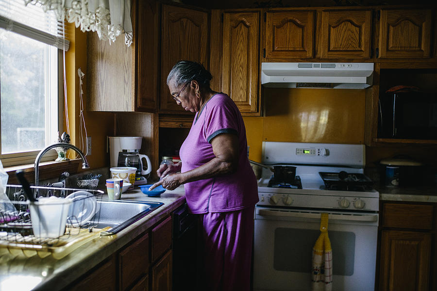 Senior black woman making breakfast Photograph by Willie B. Thomas