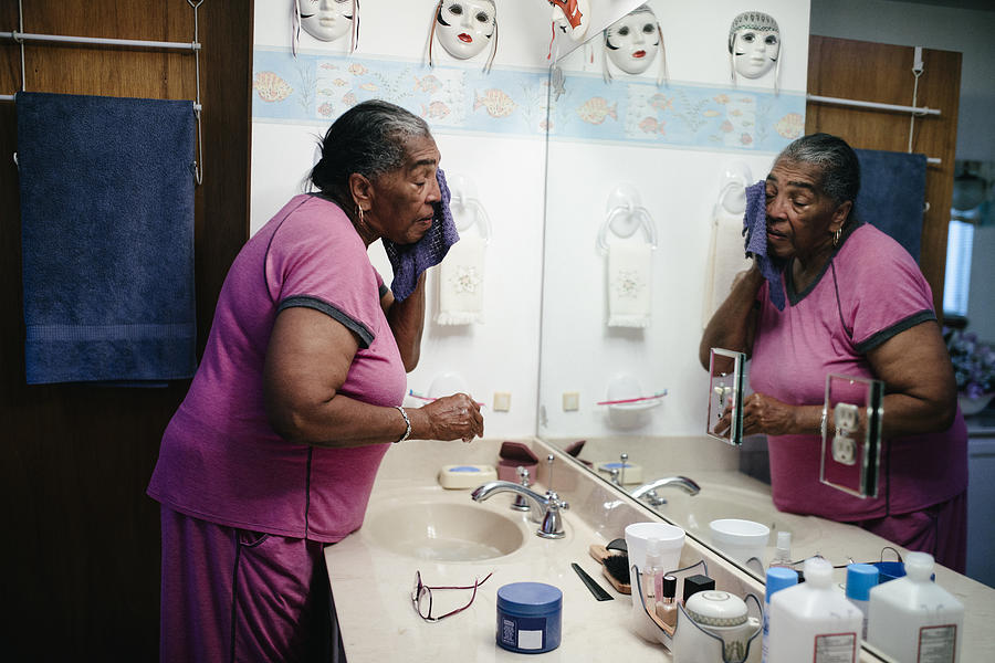 Senior black woman washing her face Photograph by Willie B. Thomas