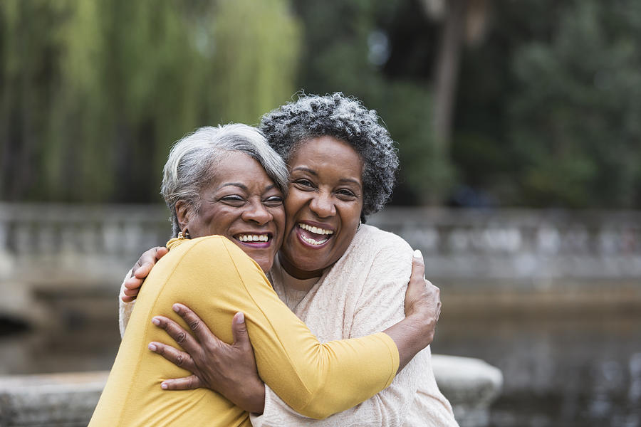 Senior black women embracing Photograph by Kali9