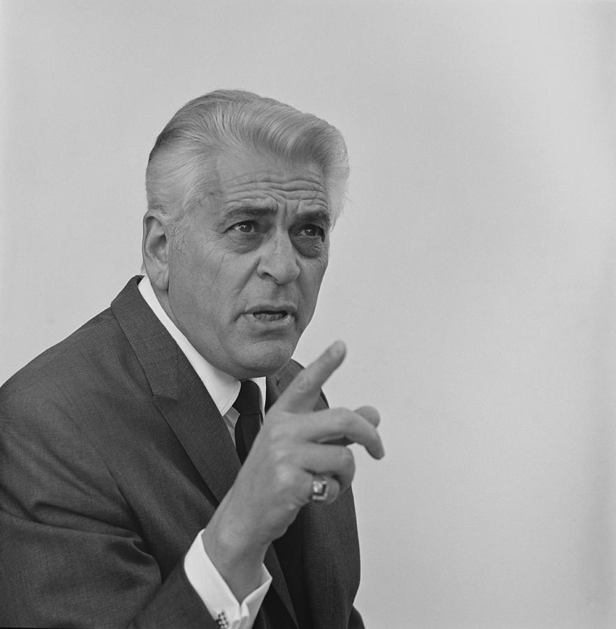 Senior businessman pointing against white background Photograph by Tom Kelley Archive