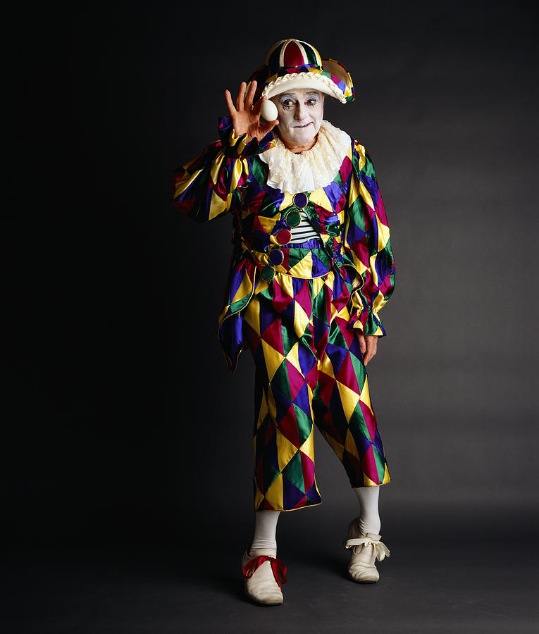 Senior clown holding egg, portrait Photograph by Blaise Hayward