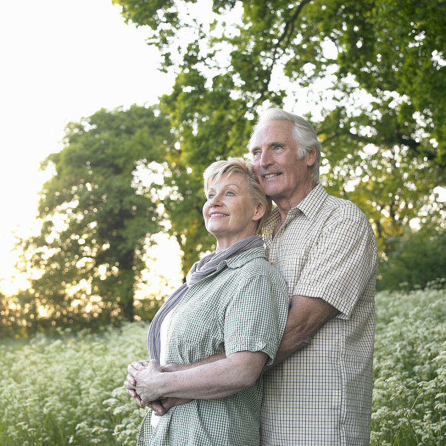 Senior couple embracing in countryside. Photograph by Dougal Waters