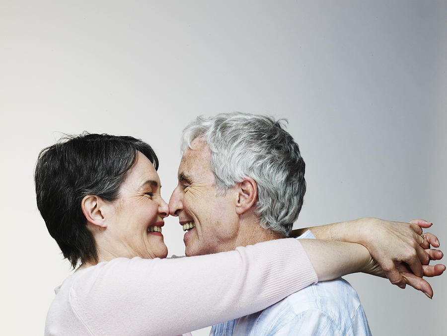 Senior couple embracing, smiling, side view Photograph by Flashpop