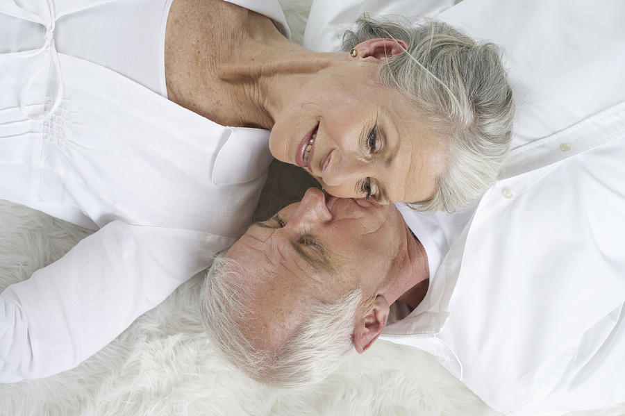 Senior couple lying head to head Photograph by Stock4b-rf