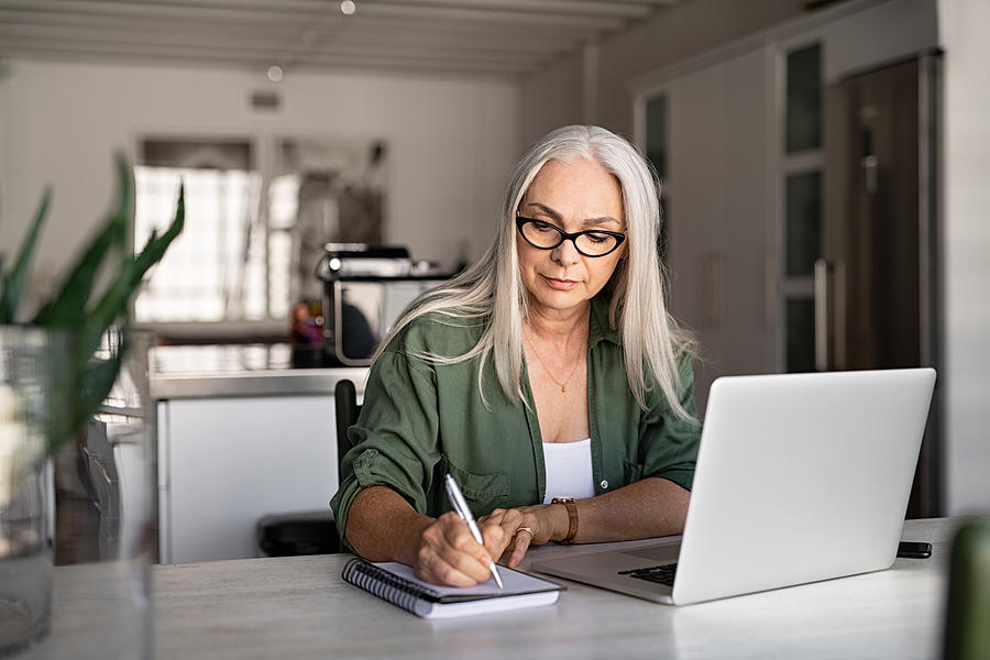 Senior fashionable woman working at home Photograph by Ridofranz