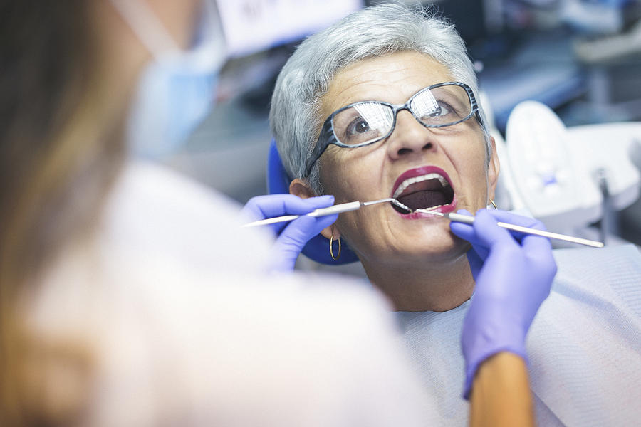 Senior female patient at dentist office Photograph by Danchooalex