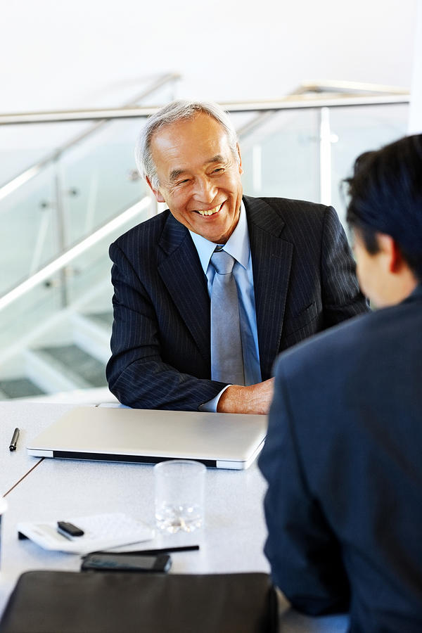 Senior japanese businessman in meeting with a young colleague Photograph by Dean Mitchell