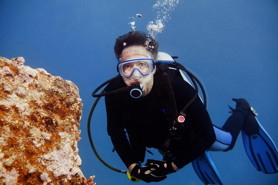 Senior Male Scuba Diver looking at camera with copy space Photograph by JodiJacobson