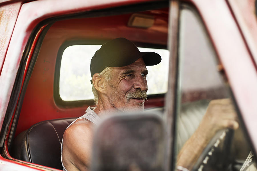 Senior man driving an old pick up Photograph by Westend61