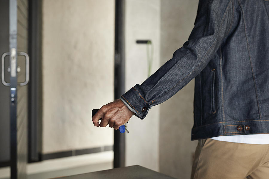 Senior man grabbing keys, when leaving apartment Photograph by Klaus Vedfelt
