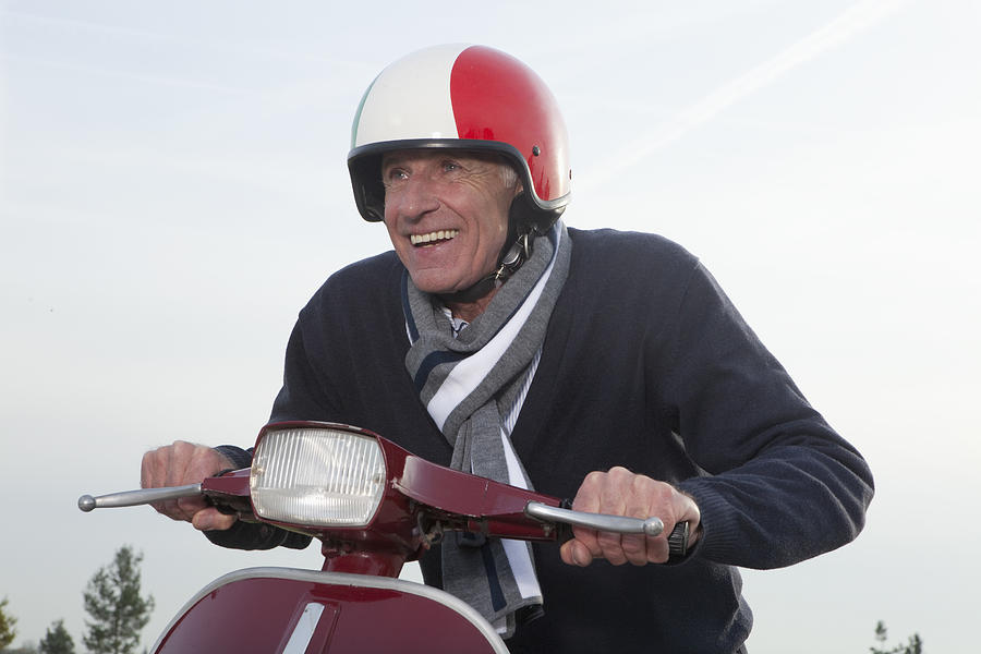 Senior man on scooter Photograph by Severin Schweiger / Bernhard Haselbeck