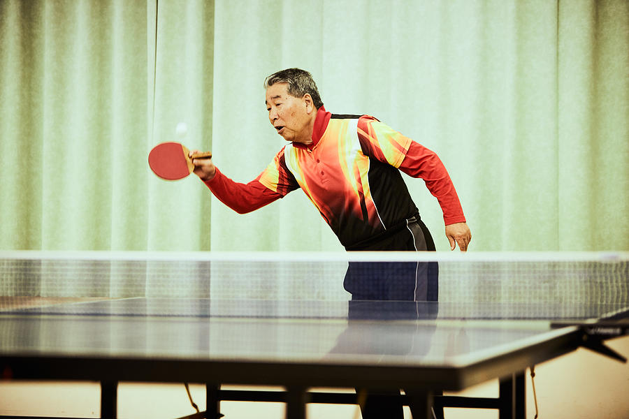 Senior man playing table tennis Photograph by Yoshiyoshi Hirokawa