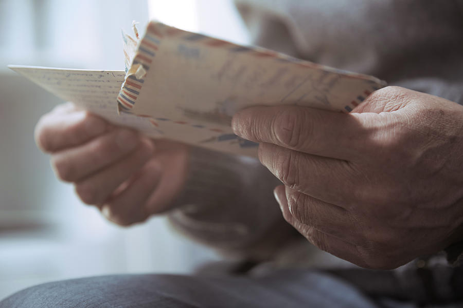 Senior man reading old letters Photograph by Arman Zhenikeyev