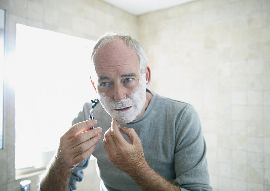 Senior man shaving Photograph by Pamplemousse
