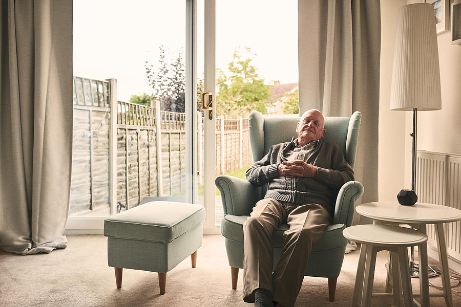 Senior man sleeping on a armchair Photograph by Dean Mitchell