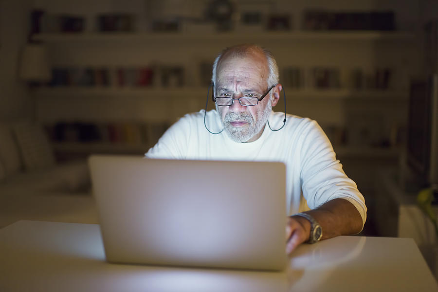 Senior man using a laptop Photograph by Thanasis Zovoilis