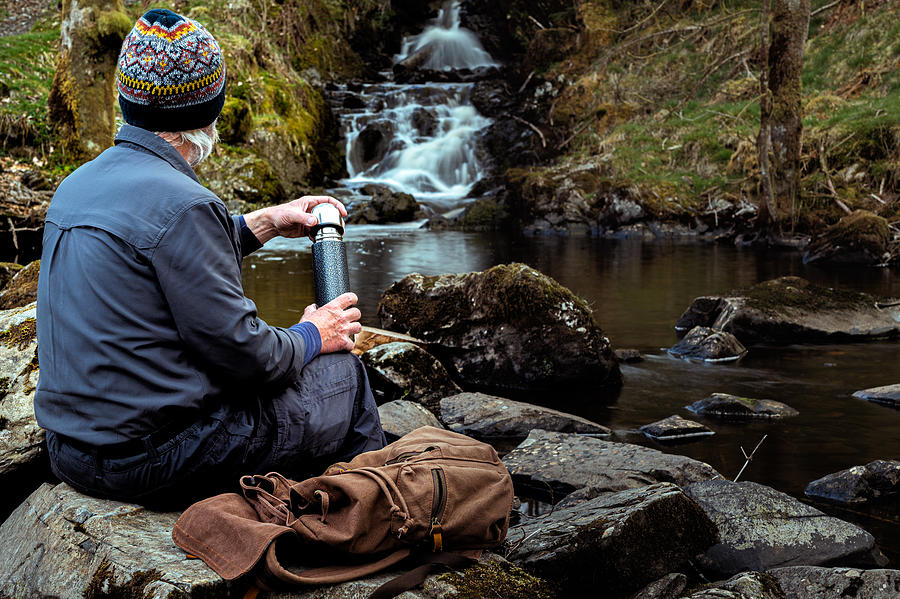 Senior man with a thermos flask at a waterfall Photograph by JohnFScott