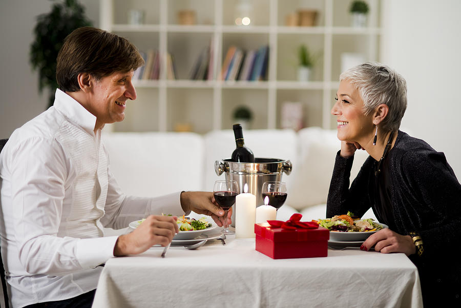 Senior- mature couple enjoying in romantic dinner Photograph by Vesnaandjic