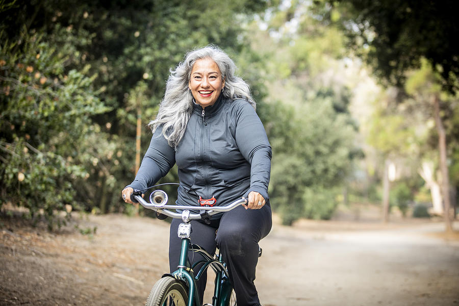 Senior Mexican Woman Riding Bicycle Photograph by Adamkaz