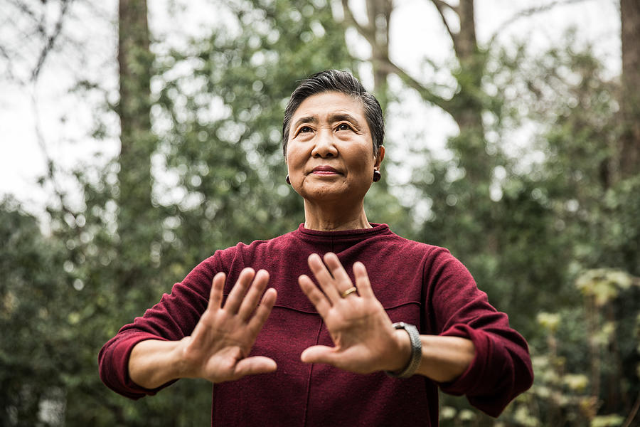 Senior woman doing Tai Chi outdoors Photograph by MoMo Productions