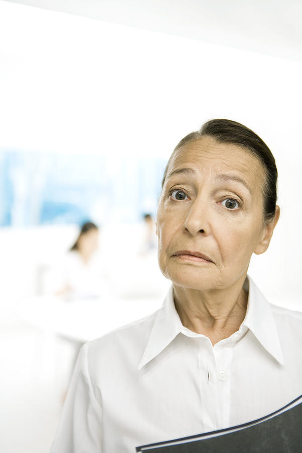 Senior woman frowning at camera, eyebrows raised Photograph by PhotoAlto/Sigrid Olsson
