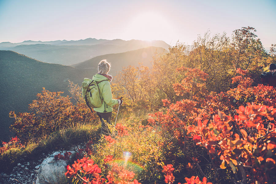 Senior Woman Hiking at Autumnal Dawn in Southern Julian Alps, Europe Photograph by Ababsolutum