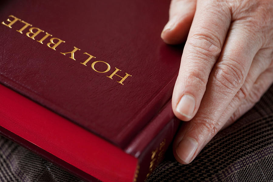 Senior woman holding bible Photograph by Image Source