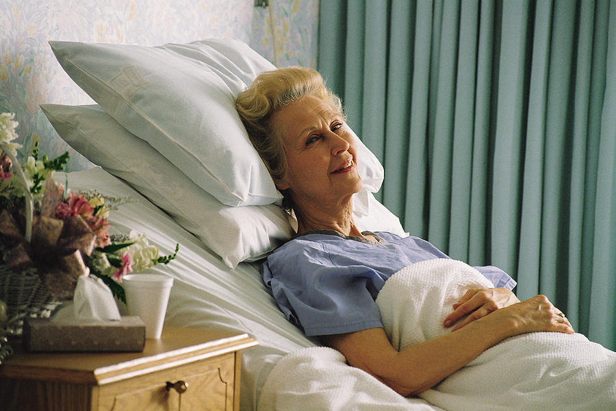 Senior woman in hospital bed Photograph by Comstock