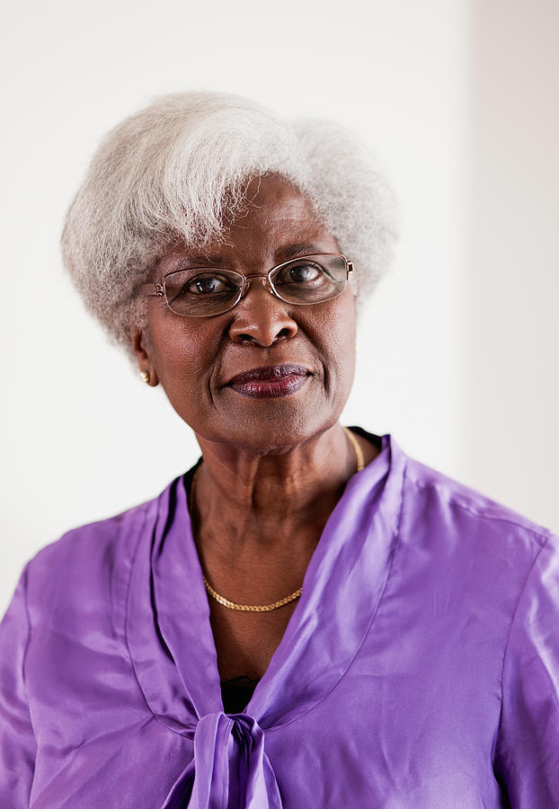 Senior woman in purple blouse, portrait Photograph by Ron Levine