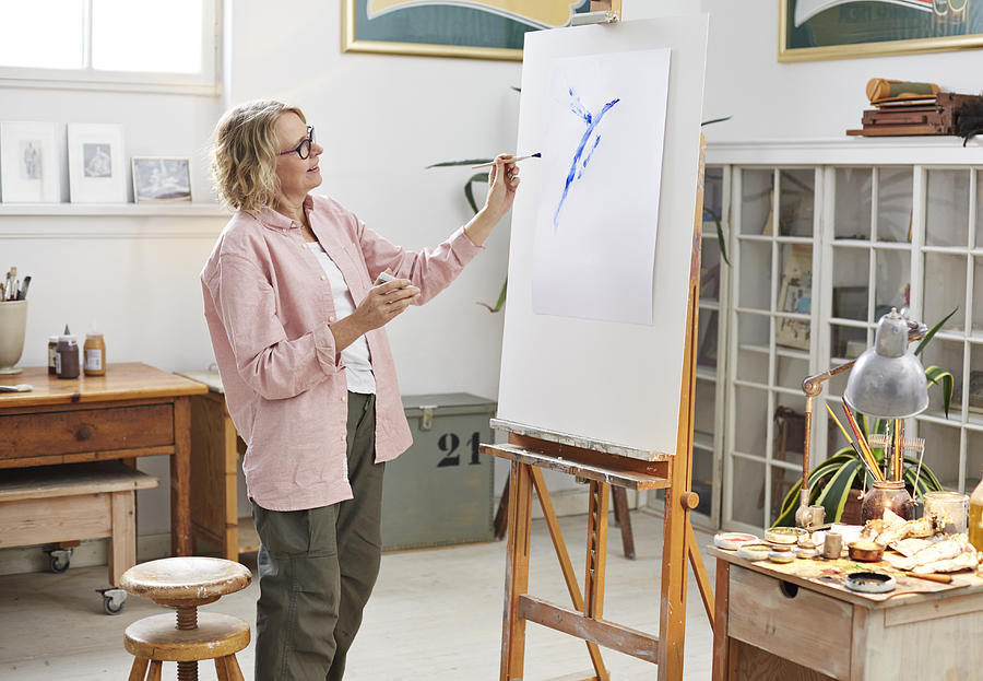 Senior woman painting at her home studio Photograph by Klaus Vedfelt
