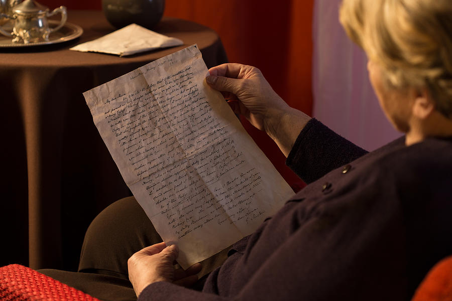 Senior woman reading yellowed letter Photograph by KatarzynaBialasiewicz