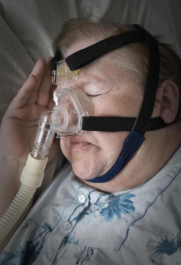 Senior Woman Sleeping with CPAP Mask Photograph by JKristoffersson