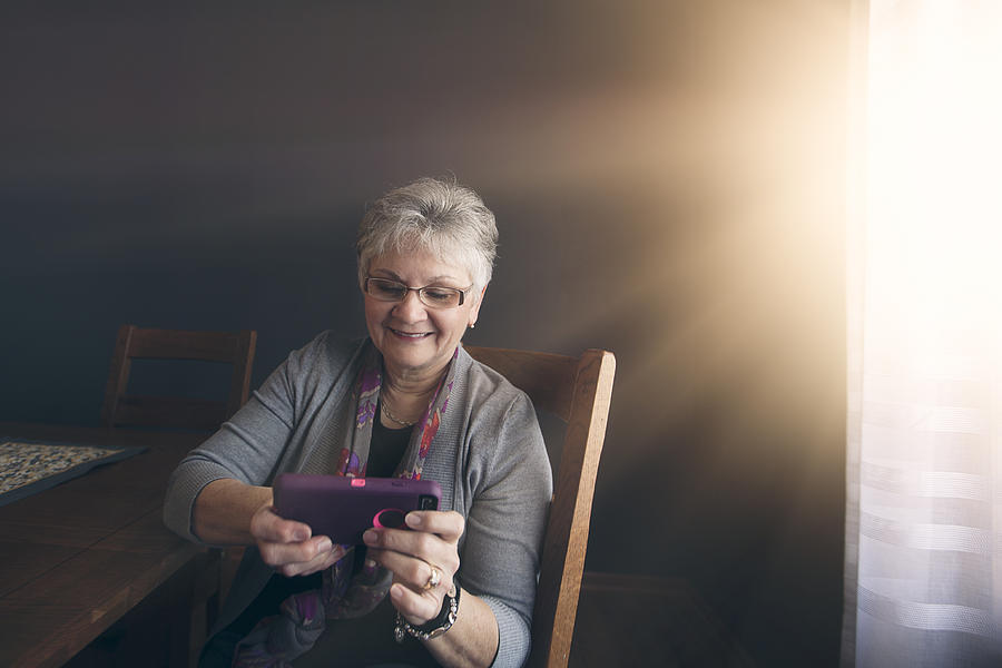 Senior Woman Using Smart Phone Photograph by Rebecca Nelson