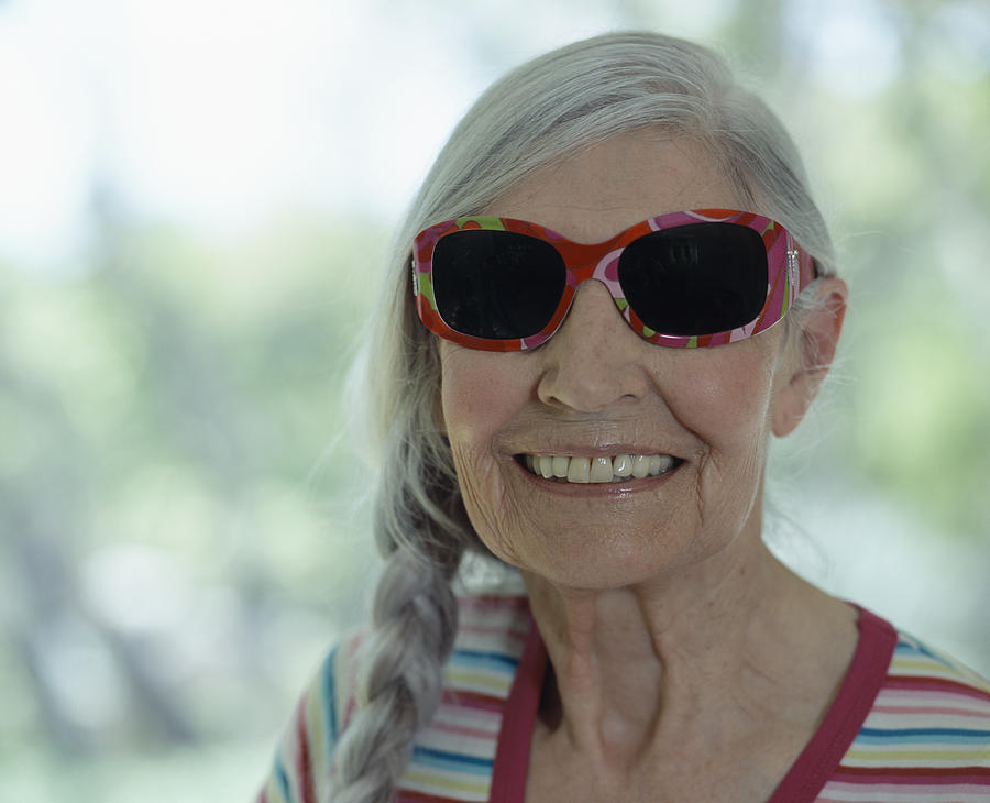 Senior woman wearing sunglasses, smiling, close-up Photograph by Bob Thomas