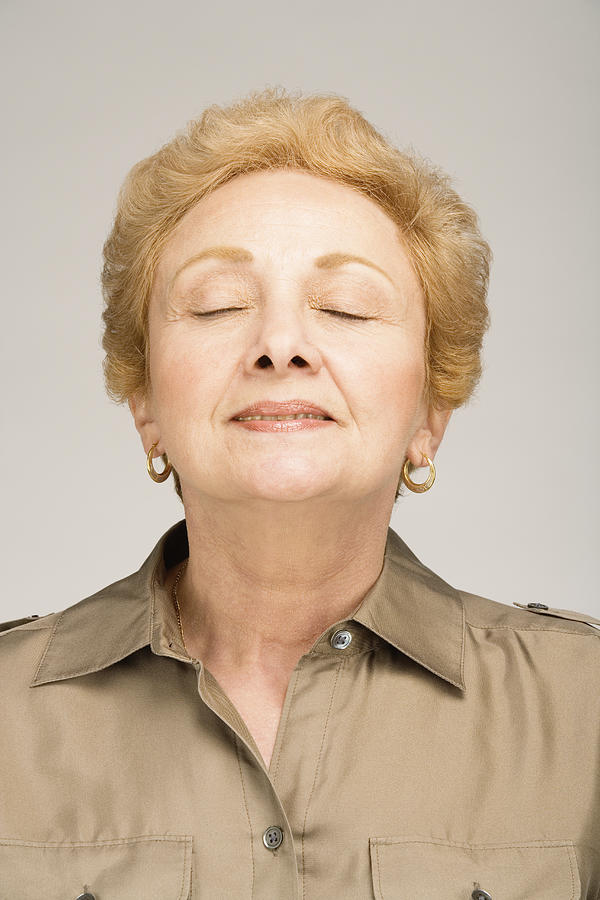 Senior woman with eyes closed, smiling, close-up Photograph by Paul Burns