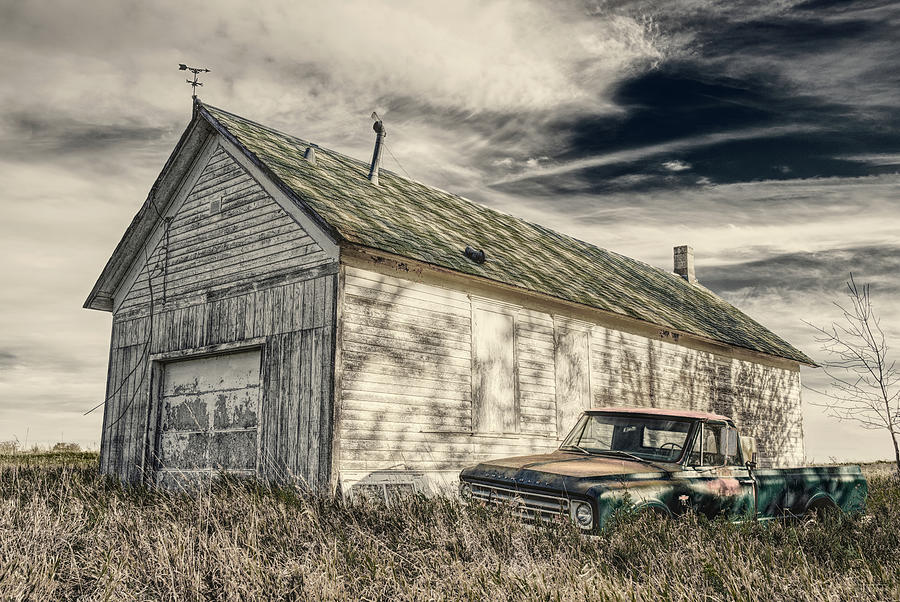 Sequestered - 1967 chevy pickup behind an old one-room schoolhouse converted to shed Photograph by Peter Herman