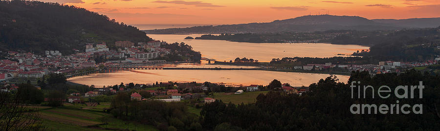 Serene dusk panorama of the medieval fishing town of Pontedeume with its iron and stone bridge sky Corua Galicia Photograph by Pablo Avanzini