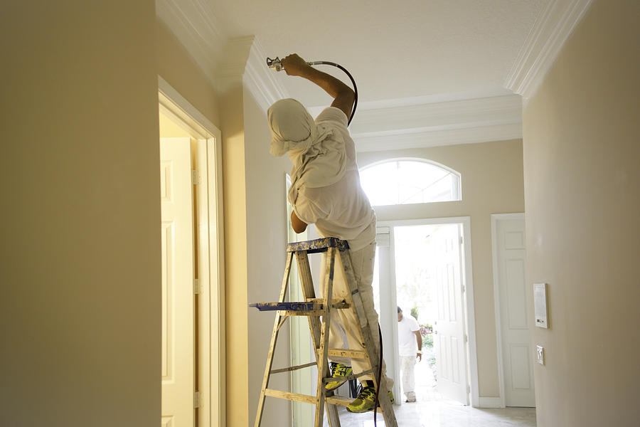 Series-Real painter spraying crown molding in a home Photograph by JodiJacobson