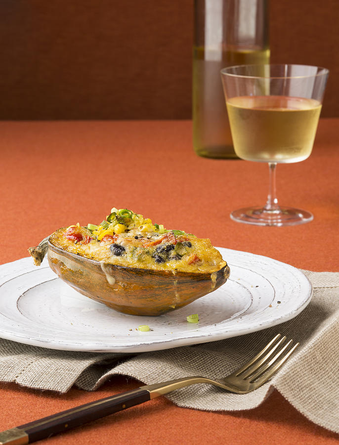 Serving of stuffed acorn squash w/glass of wine Photograph by Lisa Romerein