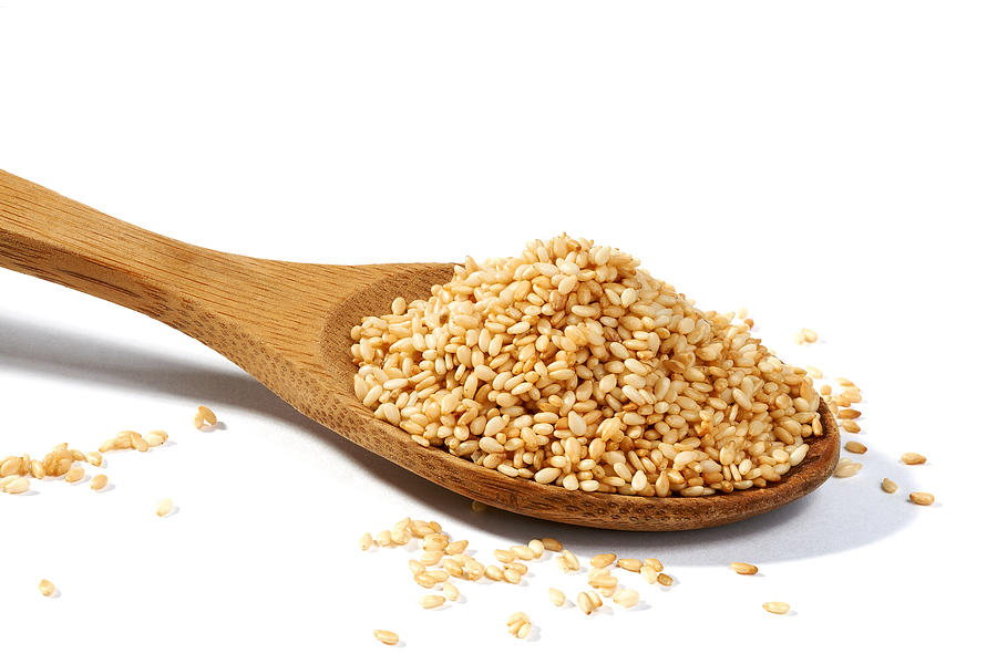 Sesame grains in large wooden spoon Photograph by Ecobo